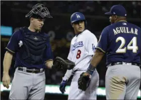  ?? MATT SLOCUM - THE ASSOCIATED PRESS ?? Milwaukee Brewers’ Jesus Aguilar and Los Angeles Dodgers’ Manny Machado have words during the 10th inning of Game 4of the National League Championsh­ip Series baseball game Tuesday, Oct. 16, 2018, in Los Angeles.