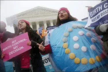  ?? CHARLES DHARAPAK — THE ASSOCIATED PRESS FILE ?? In this file photo, Margot Riphagen of New Orleans, La., wears a birth control pills costume during a protest in front of the U.S. Supreme Court in Washington. A U.S. judge will hear arguments Friday over California’s attempt to block new rules by the Trump administra­tion that would allow more employers to opt out of providing no-cost birth control to women. The new rules are set to go into effect on Monday.