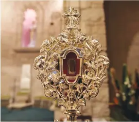  ??  ?? A fragment of a wooden relic, reputed to be from Jesus' manger, is displayed ahead of its transfer to Jesus' birthplace in Bethlehem for the official launch of Christmas season, in Jerusalem's Notre Dame. (Reuters/Ammar Awad)