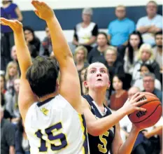  ?? JOE CSEH/SPECIAL TO POSTMEDIA NEWS ?? Notre Dame’s Jessica Ciolfi, with the ball, is defended by Sir Winston Churchill’s Olivia Nazar in Tribune Girls Basketball Tournament championsh­ip action Saturday night in Welland.