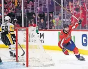  ?? [NICK WASS/THE ASSOCIATED PRESS] ?? Washington right wing Brett Connolly, right, celebrates his goal during the second period during Game 2 as Pittsburgh defenseman Kris Letang skates away, Sunday in Washington.