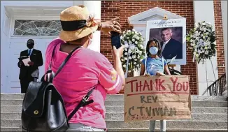  ??  ?? Members of the public pay their respects in front of the church before the start of the funeral of civil rights icon C.T. Vivian. He was laid to rest Thursday at Westview Cemetery.