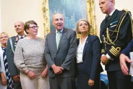  ?? J. SCOTT APPLEWHITE/AP ?? Senate Majority Leader Chuck Schumer, center, welcomes Paivi Nevala, left, minister counselor of the Finnish Embassy, and Karin Olofsdotte­r, Sweden’s ambassador to the U.S,, to witness Wednesday’s vote on NATO membership for both countries.