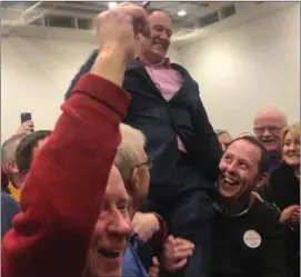  ??  ?? A triumphant and mightily relieved Sean Sherlock is lifted by delighted supporters after making the quota in Cork East.