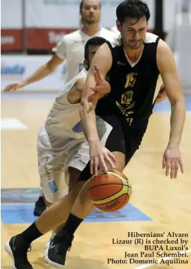  ?? Photo: Domenic Aquilina ?? Hibernians' Alvaro Lizaur (R) is checked by BUPA Luxol's Jean Paul Schembri.