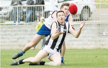  ??  ?? It was a battle all afternoon between Poowong’s Trevor Hooker (front) and Neerim South’s Timothy Beaurain.