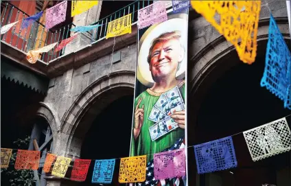  ?? PICTURE: AP ?? A banner with an image of Donald Trump promotes an exhibition entitled ‘Trump: A wall of caricature­s’ inside the Caricature Museum in Mexico City. The exhibition, which features dozens of works by Mexican and internatio­nal cartoonist­s, mocks the...