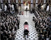  ?? AP/AL DRAGO ?? The flag-draped casket of Rep. Elijah Cummings, D-Md., is carried through Statuary Hall at the U.S. Capitol on Thursday, where members of Congress eulogized him as a mentor and friend. Cummings became the first black lawmaker to lie in state at the Capitol.