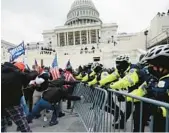  ?? JULIO CORTEZ/AP ?? Individual­s loyal to President Donald Trump try to break through a police barrier on Jan. 6, 2021, at the Capitol in Washington. A Pompano Beach man faces charges of assault.