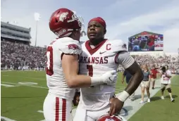  ?? NWA Democrat-Gazette/Charlie Kaijo ?? Arkansas linebacker Bumper Pool (10) consoles Arkansas quarterbac­k KJ Jefferson (1) at the end of Saturday’s football game at Vaught-Hemingway Stadium in Oxford, Miss.