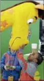 ?? THE ASSOCIATED PRESS ?? In this Feb. 14, 2016, file photo, Jahmae Evans, 4, talks to Geoffrey the Giraffe at Toy Fair in New York. Geoffrey is the corporate symbol for Toys R Us.