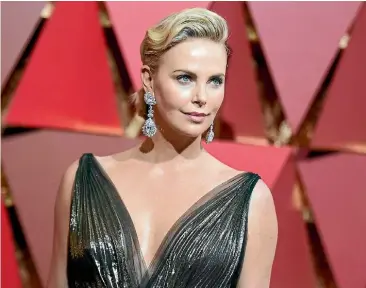  ?? AP ?? Charlize Theron sparkled at the 2017 Oscars in these dangly Chopard diamond earrings.