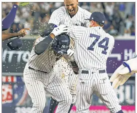  ?? Corey Sipkin; Anthony J. Causi ?? NEED FOR SEED: Miguel Andujar is showered with sunflower seeds after his bloop single with two outs in the ninth helped the Yankees pull out a 7-6 win over the Indians.