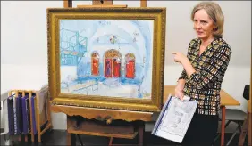  ?? Mike Corder / AP ?? Stedelijk Museum Conservato­r Madeleine Bisschoff points at Marc Chagall’s painting “The Synagogue at Safad” in Amsterdam during a presentati­on of results of a fiveyear research project into the painter.