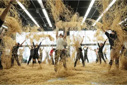  ?? CAROLYN MCCABE/PROVIDED BY JOFFREY BALLET ?? Dancers with the Joffrey Ballet toss raffia, a haylike substance, as they rehearse the opening scene of Alexander Ekman’s “Midsummer’s Night Dream,” being performed at the Lyric Opera House from April 25 through May 5.