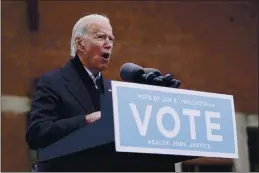  ?? PATRICK SEMANSKY — THE ASSOCIATED PRESS ?? President-elect Joe Biden speaks at a drive-in rally for Georgia Democratic candidates for U.S. Senate Raphael Warnock and Jon Ossoff on Tuesday in Atlanta.