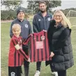  ?? ?? Reds player Cal Agus receive the new kit from sponsor Haley Garton