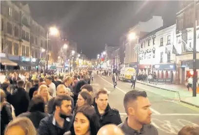  ??  ?? Hundreds of boxing fans queue for a taxi home in Cardiff city centre after trains stopped running at 11pm
