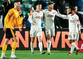  ?? — AFP photo ?? Manchester United’s striker Hojlund (second left) celebrates scoring the team’s fourth goal during the English FA Cup fourth round match against Newport County at Rodney Parade in Newport, south Wales.