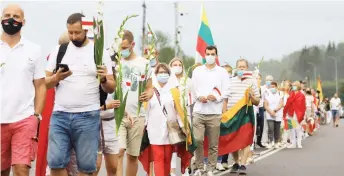  ?? — AFP photo ?? People form a human chain from Vilnius to Medininkai along the border with Belarus to show solidarity with the Belarussia­n people in Medininkai, Lithuania.