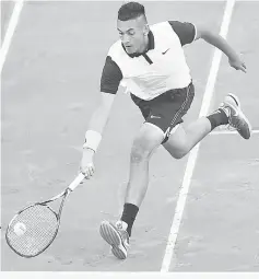  ??  ?? Kyrgios runs to return a ball to Federer during the Madrid Open tournament at the Caja Magica (Magic Box) sports complex in Madrid. — AFP photo