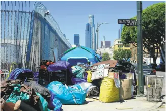  ?? Frederic J. Brown / AFP ?? A Los Angeles street corner is crowded with tents and possession­s of the homeless. The sprawling Southern California city has one of the nation’s largest homeless population­s.