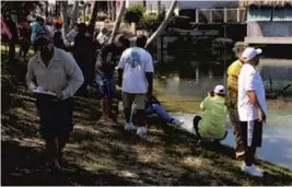  ?? STEVEWATER­S/STAFF PHOTO ?? Neal Stark of Fishing with America’s Finest, left, had more than 30 patients from the Miami VA Hospital fishing for largemouth and peacock bass this week in Dania Beach.