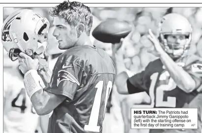  ??  ?? HIS TURN: The Patriots had quarterbac­k Jimmy Garoppolo (left) with the starting offense on the first day of training camp.