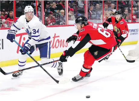  ?? WAYNE CUDDINGTON ?? Toronto’s Auston Matthews, passing the puck past Senators winger Mark Stone, had a goal in a 4-1 Leafs win Wednesday in Ottawa.