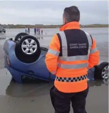  ??  ?? This is the pretty ironic scene on Bettystown beach last week when Drogheda Coastguard were called out to answer a call when a car became caught in the rising tide.