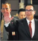  ?? Andy Wong ?? The Associated Press Treasury Secretary Steven Mnuchin waves to reporters as he arrives to a hotel after meeting with Chinese officials in Beijing on Thursday.