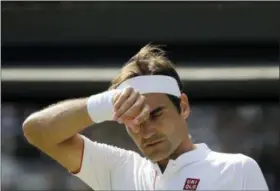  ?? BEN CURTIS—ASSOCIATED PRESS ?? Switzerlan­d’s Roger Federer wipes his forehead during the fifth set of his men’s quarterfin­als match against Kevin Anderson of South Africa at the Wimbledon Championsh­ips in London on July 11.