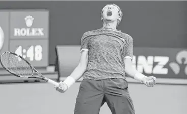  ?? Scott Barbour / Getty Images ?? Denis Istomin of Uzbekistan celebrates winning his second-round match over Serbia’s Novak Djokovic at the Australian Open. Istomin had not won a set in six previous matches against Djokovic.