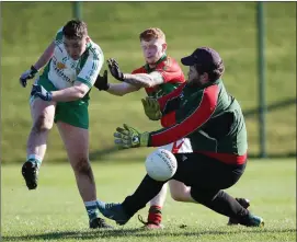  ??  ?? Tadgh O’ Toole of Shamrocks gets his shot off as Rathnew’s Paddy Reynolds and Anto O’Brien attempt to block during the under-20 football clash in Baltinglas­s.