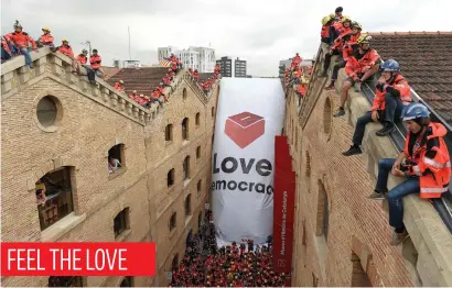  ?? Picture: AFP ?? Catalan firefighte­rs unfold a banner with a ballot box in front of the Museum of History of Catalonia in Barcelona yesterday. Prosecutor­s have ordered police to seal off polling stations until Sunday.