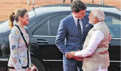  ?? MANISH SWARUP / THE ASSOCIATED PRESS ?? Indian Prime Minister Narendra Modi welcomes his Canadian counterpar­t Justin Trudeau as he arrived at the Indian presidenti­al palace in New Delhi on Friday with his wife, Sophie Gregoire Trudeau.