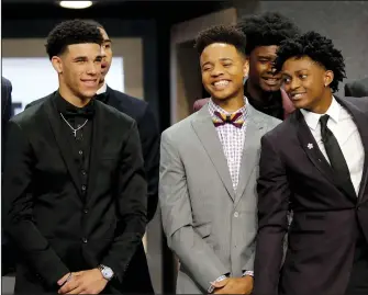  ?? YONG KIM/TRIBUNE NEWS SERVICE ?? Markelle Fultz is flanked by De'Aaron Fox, right, and Lonzo Ball during a group photo session before the start of the NBA Draft at the Barclays Center in Brooklyn, New York, on Thursday. Fultz went first overall to the 76ers, Ball was drafted second by...