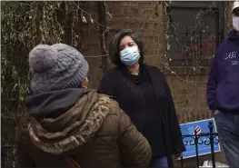  ?? PHOTOS BY EMILY LESHNER — THE ASSOCIATED PRESS ?? Sofia Moncayo, who leads a food distributi­on program through Mosaic West Queens Church in the Sunnyside neighborho­od of the Queens borough of New York speaks with a donation recipient, on Feb. 22. Moncayo and dozens of volunteers distribute more than 1,000boxes of food to families twice a week.