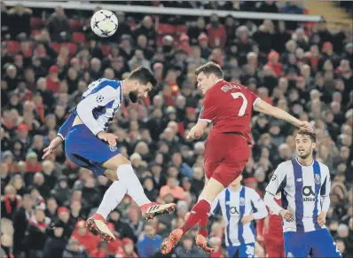  ??  ?? James Milner, right, powers a header goalwards for Liverpool in their goalless draw with Porto.