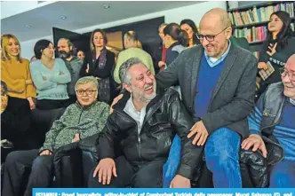  ?? —AFP ?? ISTANBUL: Freed journalist­s, editor-in-chief of Cumhuriyet Turkish daily newspaper, Murat Sabuncu (C), and Turkish journalist Ahmet Sik (R), are seen surrounded by fellow colleagues.