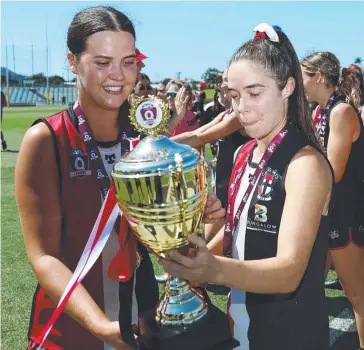  ?? Picture: Brendan Radke ?? Cairns Saints Best on Ground Grace Perry and captain Kate Fowles celebrate winning the AFL Cairns Women’s grand final.