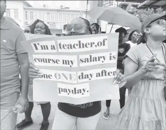  ?? ?? A striking teacher stating her position on her placard