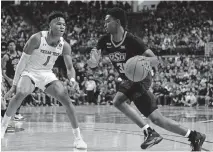  ?? [MICHAEL C. JOHNSON/USA TODAY SPORTS] ?? Oklahoma State guard Dee Mitchell (31) works the ball against Texas Tech guard Terrence Shannon Jr. (1) in the second half at United Supermarke­ts Arena in Lubbock on Jan. 4.