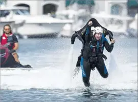  ?? Scott Smeltzer Daily Pilot ?? JETPACK AMERICA’S permit included a limit of one jet pack in Newport Harbor at a time. Above, customer Eli Delgado takes a ride with the device in 2015.