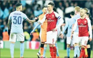  ?? GLYN KIRK/AFP ?? Manchester City defender Nicolas Otamendi (left) shakes hands with Arsenal defender Laurent Koscielny after the English League Cup final on Sunday.