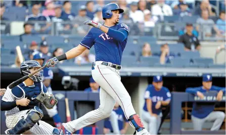  ?? AP-Yonhap ?? Texas Rangers’ Ronald Guzman, right, watches his RBI-single during the eighth inning of a baseball game against the New York Yankees, Monday, in New York.