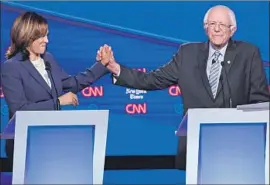  ?? Saul Loeb AFP/Getty Images ?? BERNIE SANDERS of Vermont, who made a robust case for himself despite his heart attack two weeks ago, with fellow Sen. Kamala Harris of California.