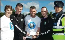  ??  ?? Castlegreg­ory Celtic FC presented €150 to Recovery Haven ahead of the walk. (From left) Mary Lynch (Rec Haven), Brian Goggin, Aaron Deane and Domnick Spillane (CCFC) and Garda Nina Long.
