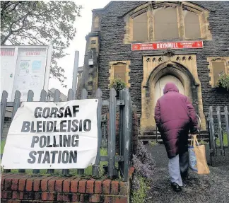  ?? Dimitris Legakis ?? > A woman enters the polling station in Brynmill Community Centre in Swansea