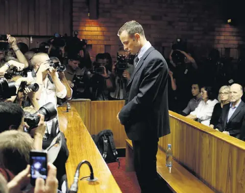  ??  ?? ACCUSED OF MURDER: Oscar Pistorius in the dock of a Pretoria magistrate­s court. After being released on bail on Friday the Paralympic gold medallist told his uncle that the ‘family of Reeva is on his mind all the time’. Photo: Mike Hutchings